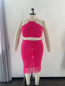 Detail of rose red crochet two-piece set featuring tassel fringe and knit texture