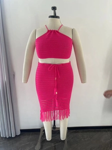 Detail of plus size crochet knit set in hot pink with fringed skirt and drawstring neck