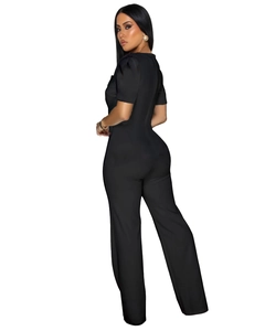 Detail of the back view of a slim-fit black short sleeve jumpsuit with minimalist lines