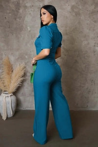 Detail view of teal short sleeve jumpsuit with puff sleeves and slim fit design