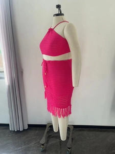 Detail of crochet texture and tassel hem on two-piece hot pink plus size knit set