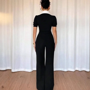 Elegant sleeveless jumpsuit with white polo collar and wide leg design in black