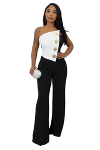 Detail of elegant two-tone jumpsuit with gold buttons and one-shoulder bodice