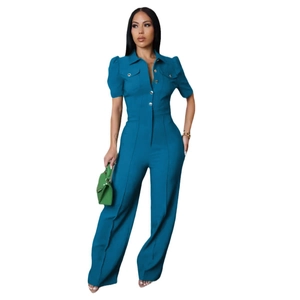 Detail of navy blue short sleeve jumpsuit with turn-down collar and silver metal buttons