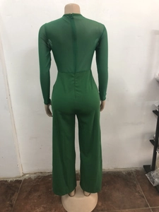 Detail view of the back of a green mesh patchwork long sleeve jumpsuit with a zipper closure