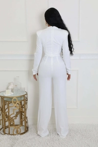 Rear view of white wide-leg jumpsuit showing back zipper and shoulder padding details
