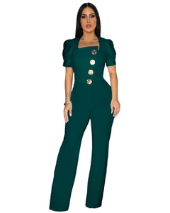 Close-up of deep green jumpsuit with puff sleeves and four large gold embossed buttons