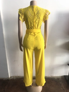 Rear view detail of bright yellow sleeveless jumpsuit with delicate lace hollow out design