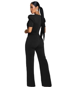 Rear view detail of black short sleeve jumpsuit showing invisible zipper and wide-leg cut