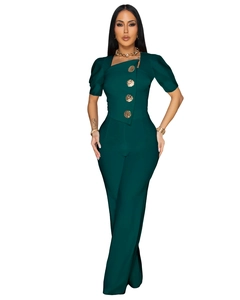 Detail of dark green short sleeve jumpsuit featuring gold embossed buttons and square neck
