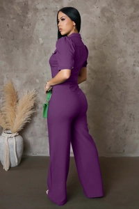 Detail of purple short sleeve jumpsuit showing cargo style collar and sleek side silhouette