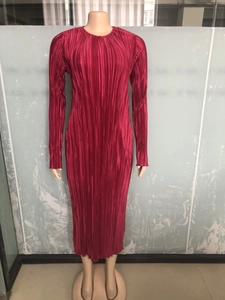 Close-up of wine red pleated maxi dress featuring vertical accordion pleats and crew neck