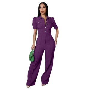 Detail of dark purple short-sleeved jumpsuit with lapel collar and metal button accents
