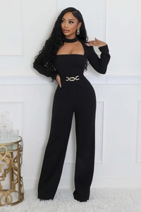 Detail of elegant black long sleeve jumpsuit featuring cutout neck and metal waist chain