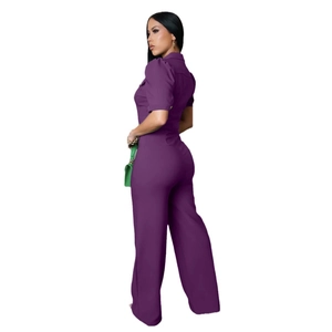 Close-up of purple short sleeve jumpsuit featuring lapel collar and front chest pockets