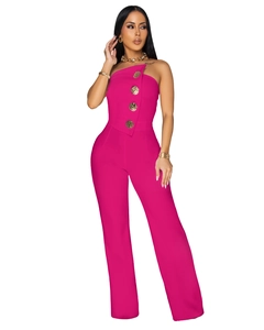 Detail of rose pink strapless jumpsuit featuring four large gold buttons and asymmetric fold