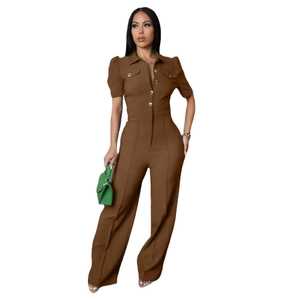 Detail view of brown short sleeve jumpsuit with metal buttons and chest flap pockets