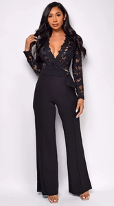 Detail of elegant black long-sleeve jumpsuit featuring lace bodice and belted waistline