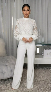 Detail of elegant white lace long sleeve top and high-waisted wide-leg trouser jumpsuit