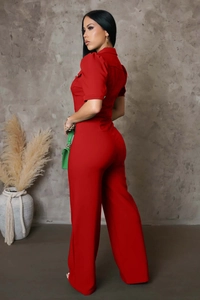 Close-up of red short sleeve jumpsuit with shirt collar and metal buttons detail