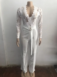 Detail of white lace long sleeve jumpsuit featuring V-neck and waist belt with ring buckle