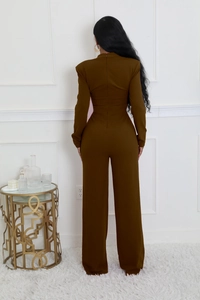 Detail view of brown wide-leg jumpsuit showing high collar and back zipper detail