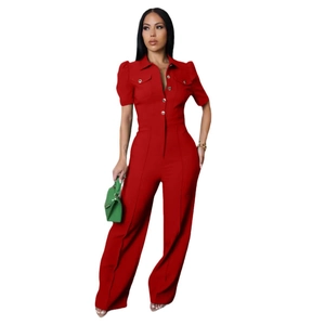 Detail of red short sleeve jumpsuit with lapel collar, button front and chest pockets