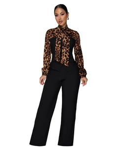 Detailed view of the leopard print blouse necktie and high-waisted black wide-leg trousers