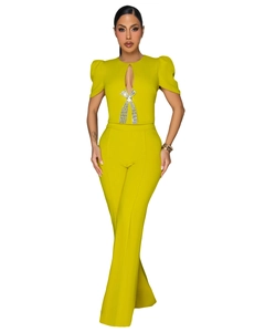 Detail of rhinestone bow decoration and teardrop cutout on mustard green jumpsuit