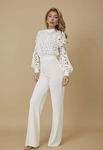 Detailed view of white semi-high neck jumpsuit with lace crochet and lantern sleeves