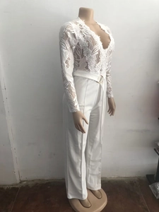 Detail of white lace long sleeve jumpsuit featuring V-neck embroidery and belted waist