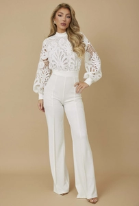 Close-up of intricate white lace embroidery and hollow-out detailing on the long sleeves