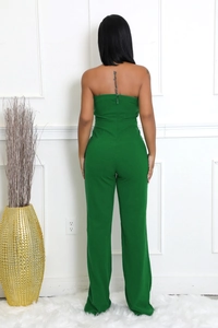 Back view of dark green strapless jumpsuit showing invisible zipper and wide leg cut