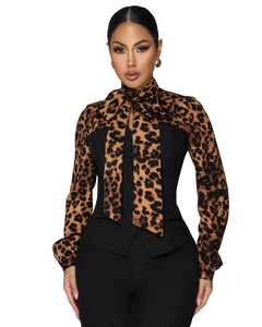 Detail of elegant leopard print patchwork blouse with large ribbon bow tie neckline