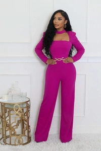 Detail of fuchsia jumpsuit featuring a square neckline with cutout and gold link belt