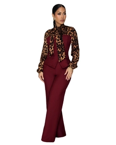 Detail of elegant leopard print chiffon shirt with bow and burgundy wide-leg trousers