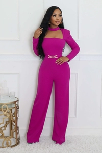 Detail of elegant magenta jumpsuit featuring a cutout neck and gold chain belt waist