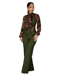 Detailed view of women's deep green jumpsuit with leopard print sleeves and bow tie detail