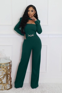 Detail of dark green wide-leg jumpsuit featuring a halter neck and golden waist chain