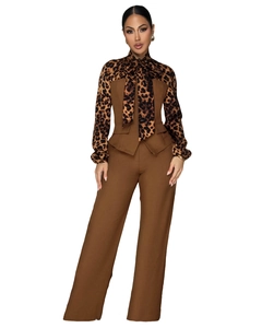 Detail of elegant two-piece set featuring leopard print bow tie and brown wide leg pants