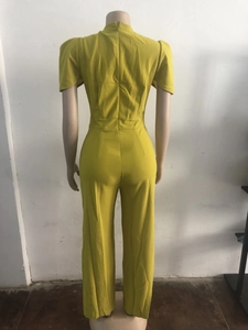 Detail view of mustard yellow wide-leg jumpsuit with short sleeves and back hidden zipper