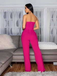 Fuchsia strapless wide-leg jumpsuit with back zipper shown in a modern home setting