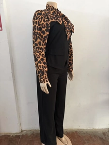 Detail view of the elegant leopard print collar with a bow tie and black vest overlay
