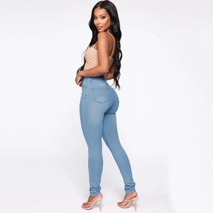 Detail view of light blue high-waisted skinny jeans showing slim fit and back pocket design