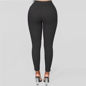 Rear view of black high-waisted skinny trousers showing slimming fit and back pockets