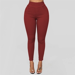 Detail of high waist slim fit burgundy leggings showing elastic stretch and sleek fabric