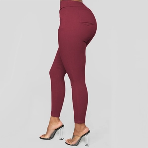 Detail view of wine red high waist slim pants with functional back pocket and curves