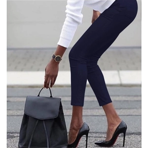 Slim fit dark blue ankle trousers styled with black high heels and a matching backpack