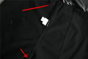 Detail view of black PU leather shorts showing reinforced stitching and XL size label