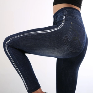 Macro detail of high waist faux denim leggings showing side white polka dot stripes